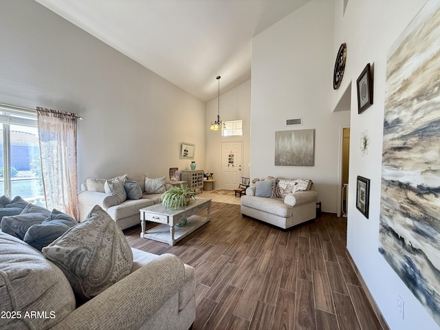 1758 E San Xavier Dr, Casa Grande, AZ 85122 - living area featuring high vaulted ceiling, dark wood-type flooring, a chandelier, and baseboards