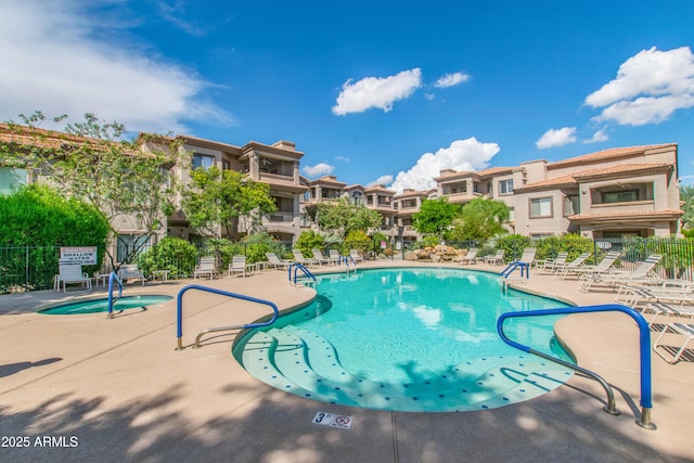 pool featuring a patio area, a residential view, and fence