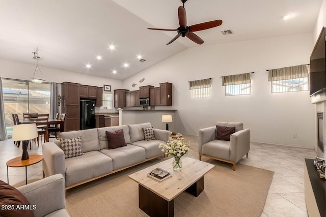 living room featuring a ceiling fan, visible vents, vaulted ceiling, recessed lighting, and light tile patterned flooring