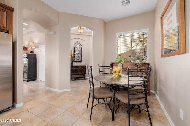 dining area featuring light tile patterned flooring