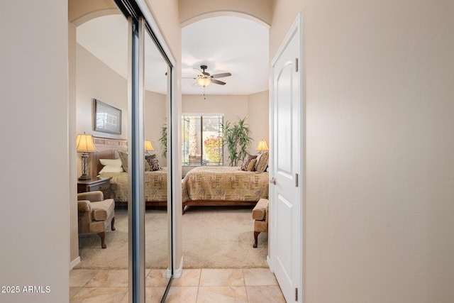 bedroom featuring light colored carpet and ceiling fan