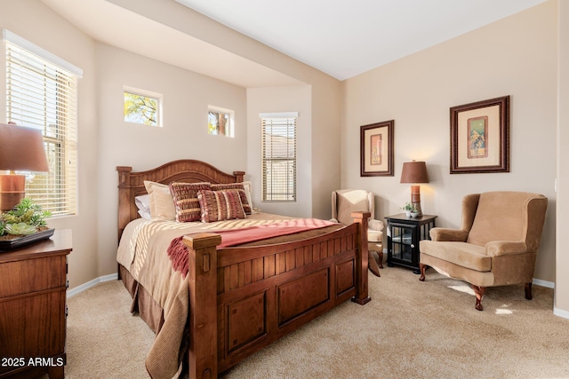 bedroom with multiple windows and light colored carpet