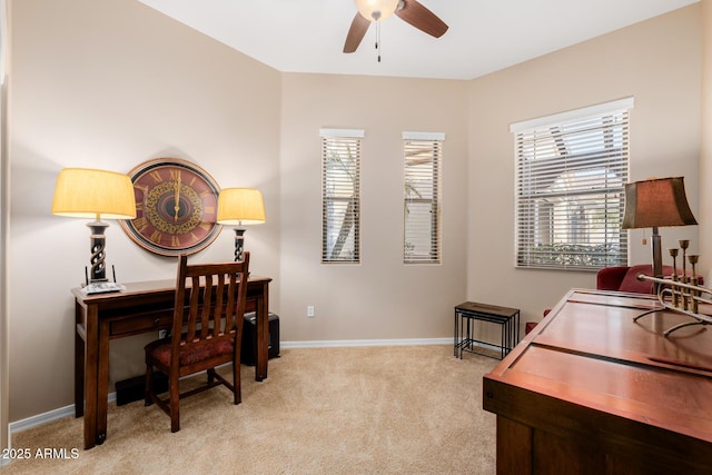 carpeted office space with ceiling fan