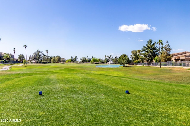 view of community with a yard and a water view