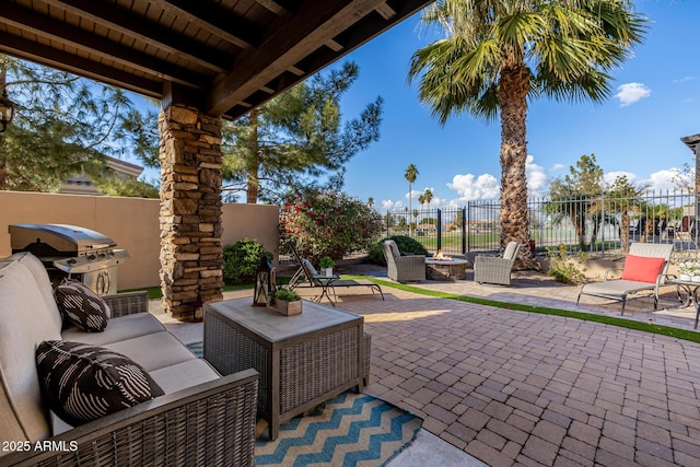 view of patio / terrace with area for grilling and an outdoor living space with a fire pit