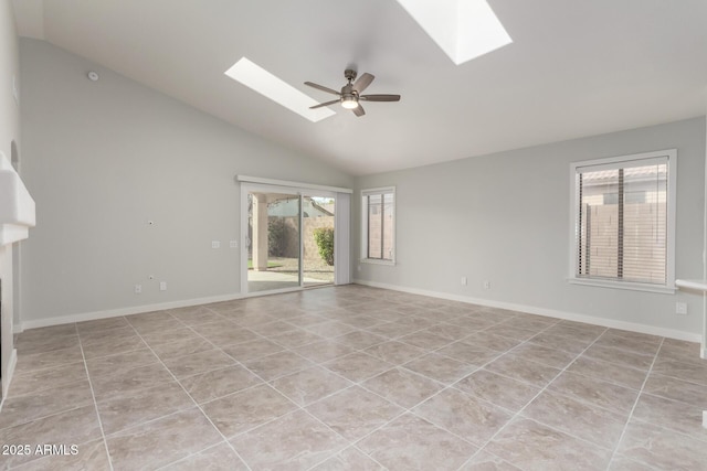 tiled spare room with ceiling fan and vaulted ceiling with skylight