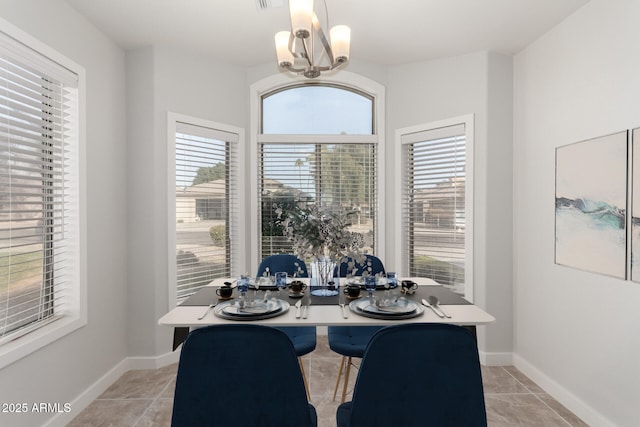 tiled dining room featuring a chandelier