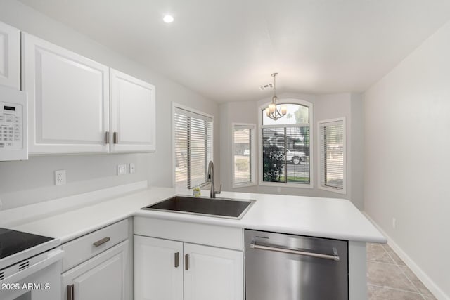 kitchen featuring sink, white appliances, kitchen peninsula, and white cabinets