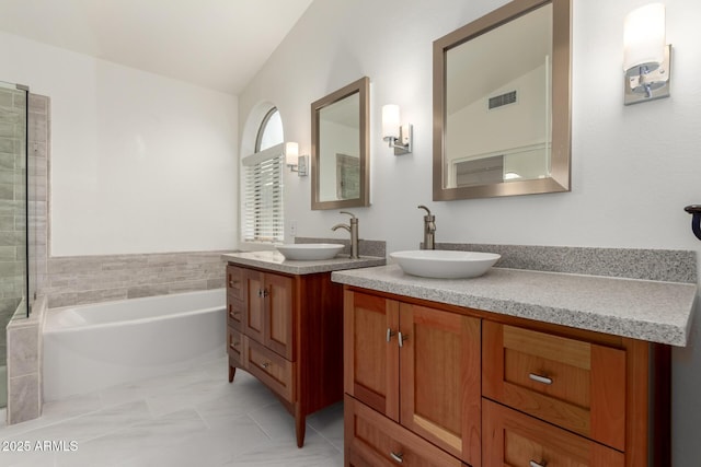 bathroom featuring vanity and a tub