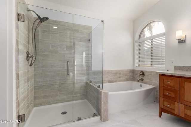 bathroom featuring vanity and plus walk in shower