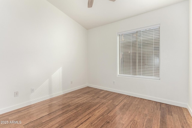 empty room with ceiling fan and wood-type flooring