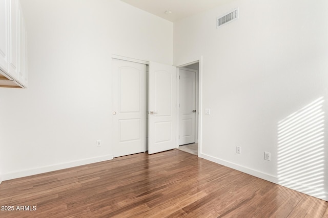 unfurnished bedroom with hardwood / wood-style floors