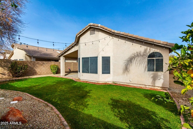 back of house with a yard and a patio area