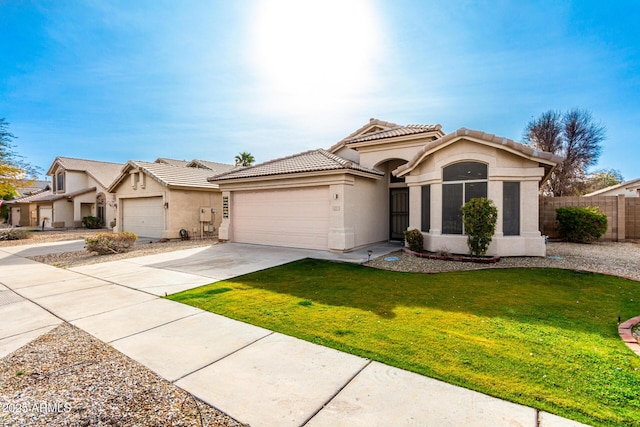 view of front of home featuring a garage and a front lawn