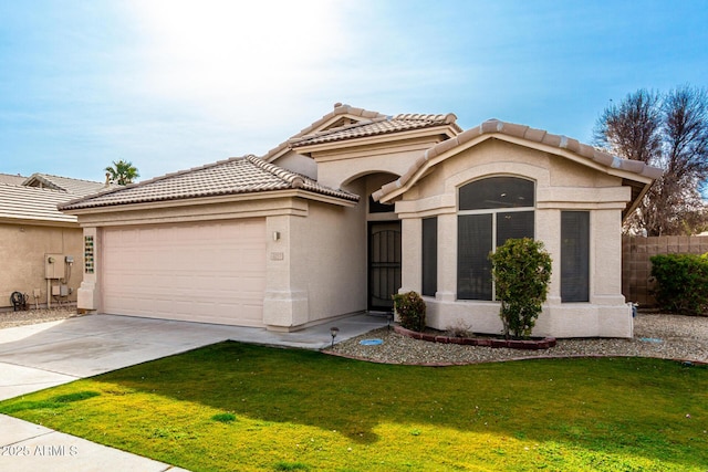 mediterranean / spanish-style house featuring a garage and a front yard