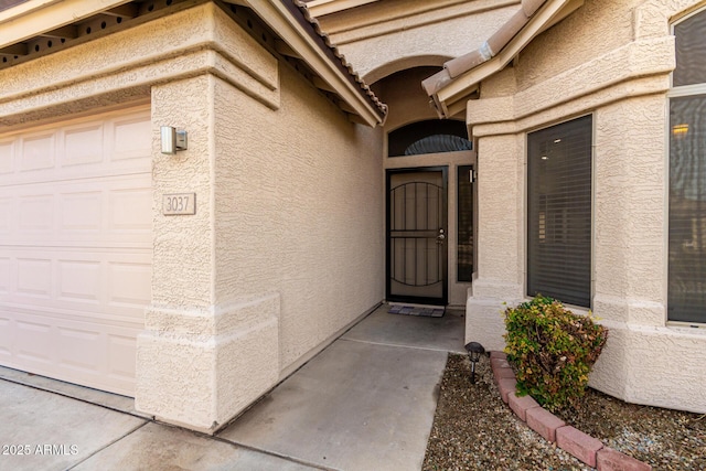 view of exterior entry featuring a garage