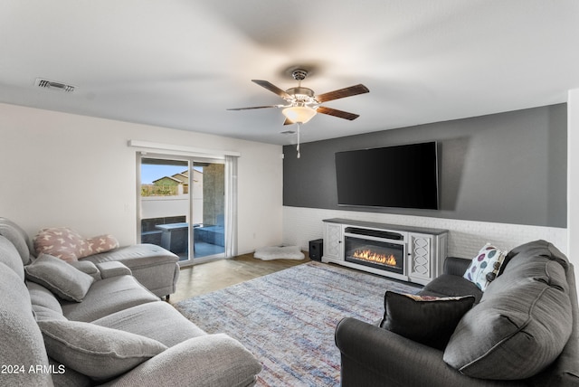 living room with light hardwood / wood-style flooring and ceiling fan