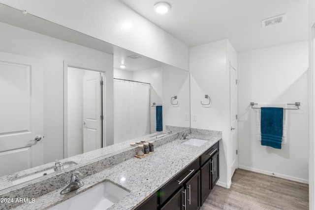 bathroom with vanity and hardwood / wood-style floors