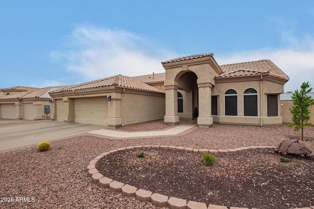 3946 N 112th Ave, Avondale, AZ 85392 - mediterranean / spanish home with a tiled roof, stucco siding, a garage, and concrete driveway