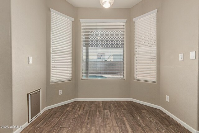 3946 N 112th Ave, Avondale, AZ 85392 - empty room featuring dark wood-style flooring and baseboards