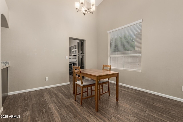 3946 N 112th Ave, Avondale, AZ 85392 - dining space with a chandelier, dark wood-style floors, baseboards, and a towering ceiling