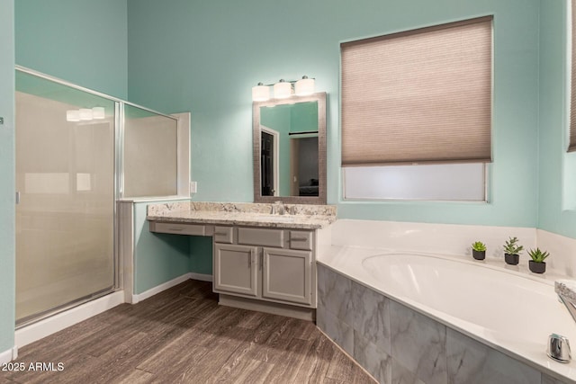 3946 N 112th Ave, Avondale, AZ 85392 - bathroom with a stall shower, a garden tub, wood finished floors, and vanity
