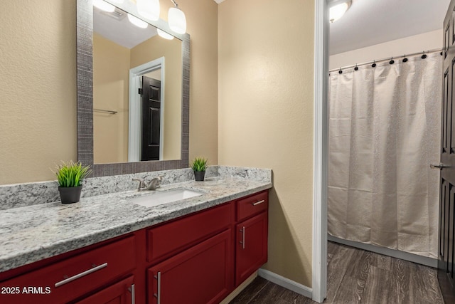 3946 N 112th Ave, Avondale, AZ 85392 - full bathroom with vanity, wood finished floors, baseboards, a textured wall, and a shower with curtain