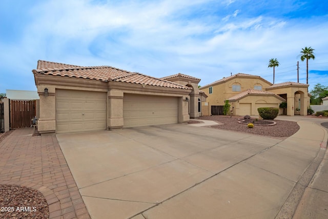 3946 N 112th Ave, Avondale, AZ 85392 - mediterranean / spanish home with concrete driveway, an attached garage, stucco siding, and a tile roof