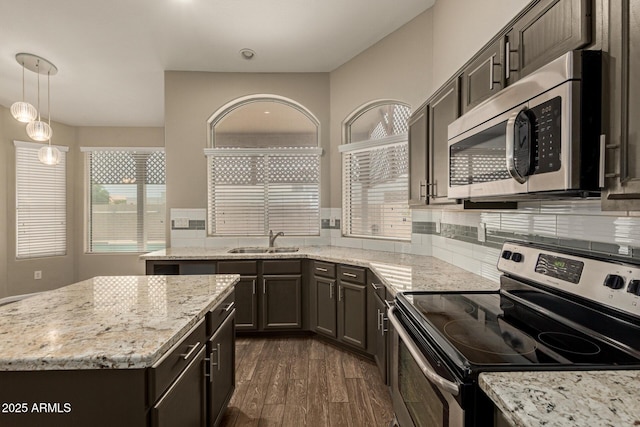 3946 N 112th Ave, Avondale, AZ 85392 - kitchen with appliances with stainless steel finishes, a sink, plenty of natural light, and light stone counters