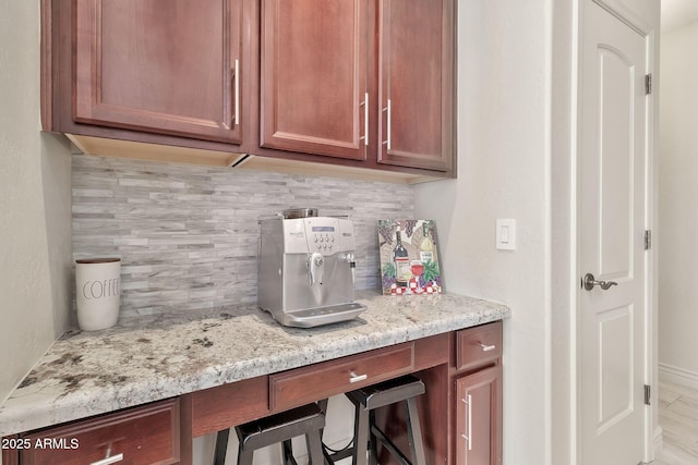 interior space with light stone countertops and tasteful backsplash