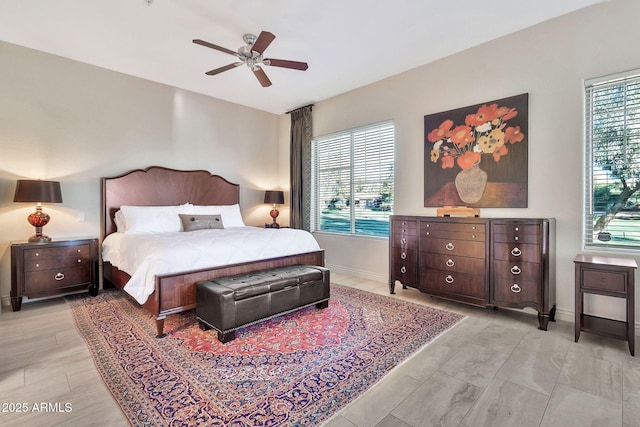 bedroom featuring multiple windows and ceiling fan