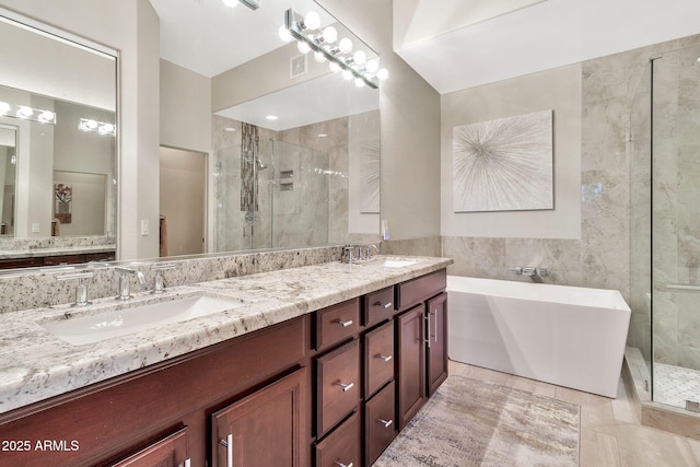 bathroom featuring independent shower and bath, tile patterned flooring, and vanity