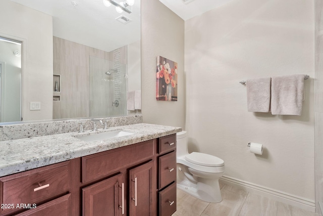 bathroom featuring a tile shower, toilet, tile patterned floors, and vanity