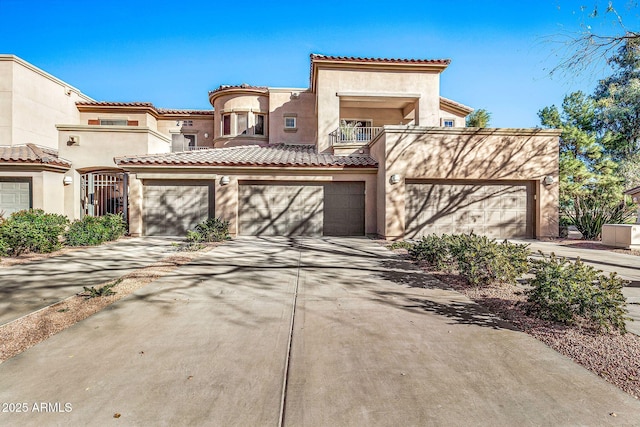 mediterranean / spanish-style house featuring a balcony and a garage