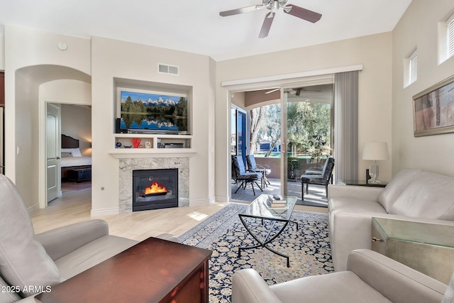 living room with ceiling fan and wood-type flooring