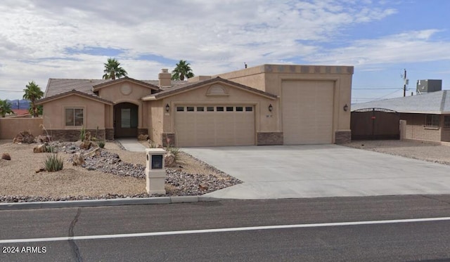 view of front of house featuring cooling unit and a garage