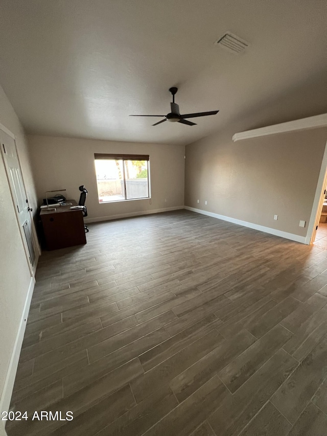 spare room with dark hardwood / wood-style floors and ceiling fan