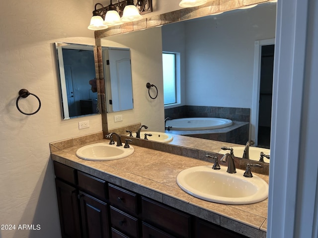 bathroom with vanity and tiled bath