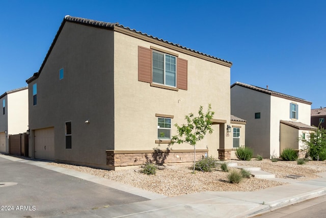 3929 S 79th Ln, Phoenix, AZ 85043 - view of side of home with an attached garage and stucco siding