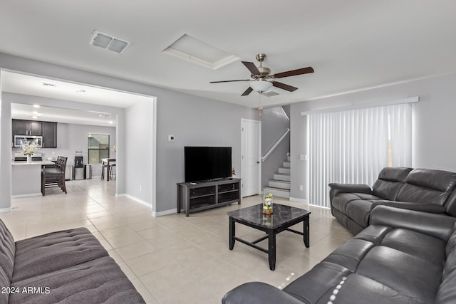 3929 S 79th Ln, Phoenix, AZ 85043 - living area with a ceiling fan, visible vents, stairway, light tile patterned flooring, and baseboards