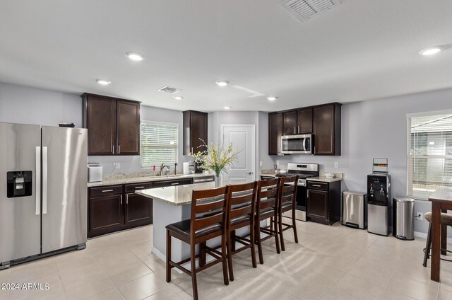 3929 S 79th Ln, Phoenix, AZ 85043 - kitchen featuring visible vents, dark brown cabinets, and appliances with stainless steel finishes