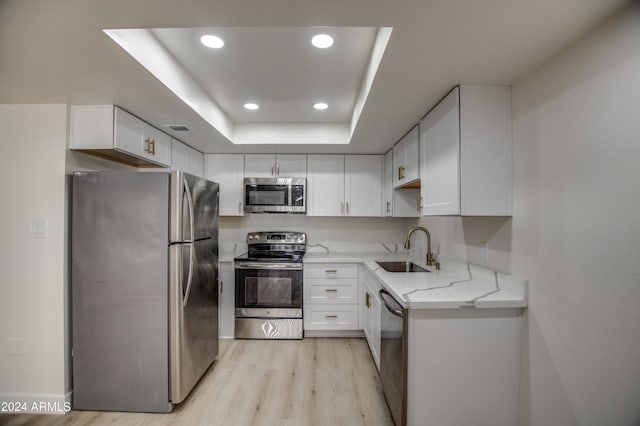 7920 E Camelback Rd Unit 609, Scottsdale, AZ 85251 - kitchen with stainless steel appliances, light stone countertops, light wood-type flooring, recessed lighting, and white cabinets