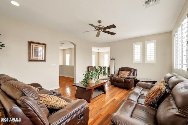 living room with ceiling fan and light wood-type flooring