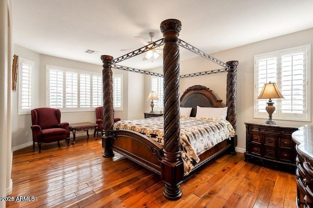 bedroom with ceiling fan and wood-type flooring