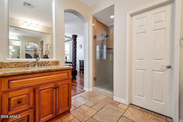 bathroom with vanity and a shower with shower door