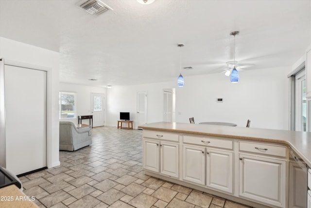 kitchen with ceiling fan and hanging light fixtures