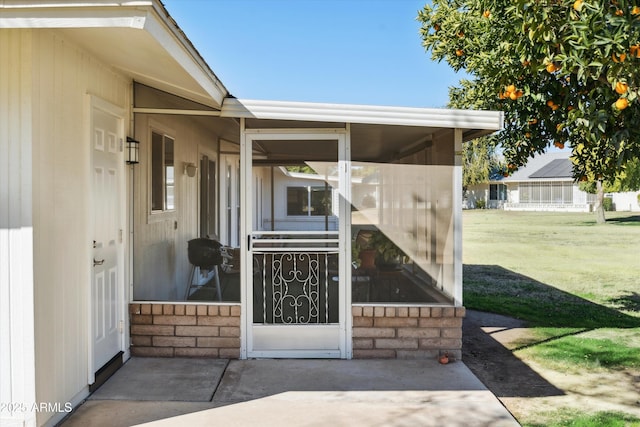 property entrance with a lawn