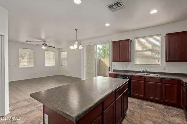 kitchen with a kitchen island, pendant lighting, ceiling fan with notable chandelier, dishwasher, and sink