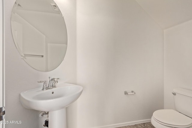 bathroom with vaulted ceiling and toilet