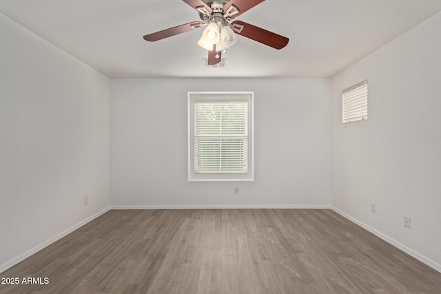 spare room with hardwood / wood-style flooring and ceiling fan